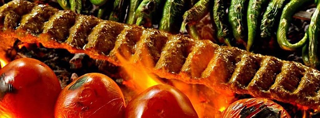 Flame-grilled kabob with charred tomatoes and peppers