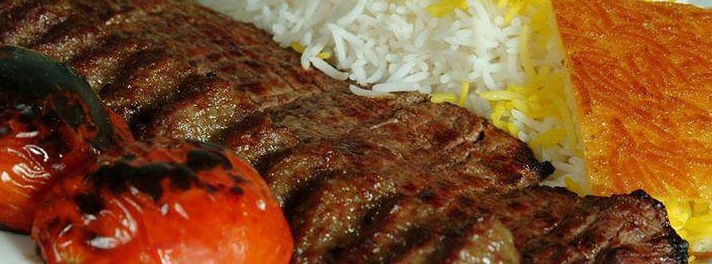 Grilled shish kabob with saffron rice and charred tomatoes