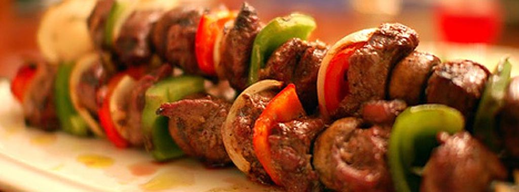 Grilled meat kabob skewer with peppers and onions at Babajoon's Kabobs