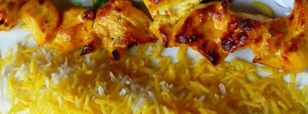 Saffron chicken kabob served over yellow rice